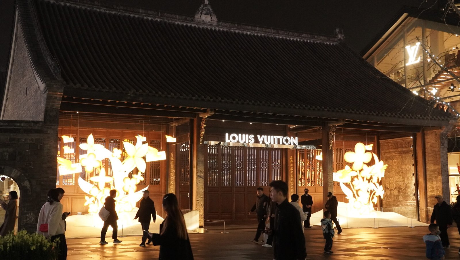 Taikoo Li at night, with luxury fashion stores set in traditional Chinese-style architecture — Photo by Tan Tai Nguyen